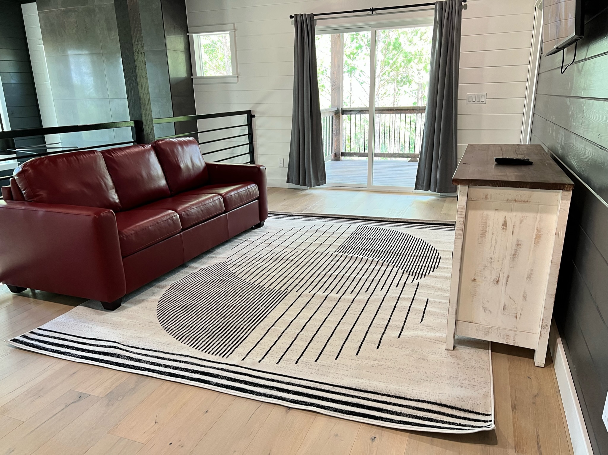 Experience an ultimate entertainment retreat in our Upstairs Loft, featuring a Queen-size bed convertible from a leather sofa, a 55" Smart TV, a Retro Arcade game with 14 classic games, and direct access to an outside balcony, offering a perfect blend of comfort, nostalgia, and scenic views for an unforgettable stay.